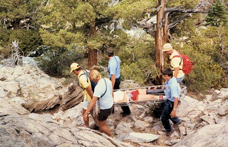 Team carrying Becky down the trail