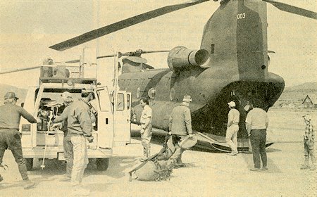 Mono County Sheriff's deputies, Mono County paramedics and members of the June Lake Mountain Rescue team load rescue gear into a Chinook helicopter