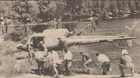 Members of the June Lake Mountain Rescue Team, paramedics from Medic III and Inyo National Forest personnel rush to load Lee Wilson Sloan of San Francisco on to a helicopter along the shore of McCloud Lake after Sloan collapsed along the trail.