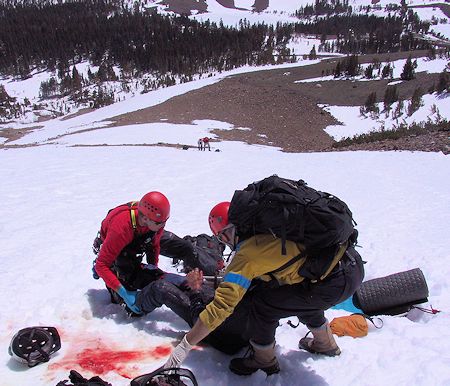 Preparing to move victim into litter - JW Photo