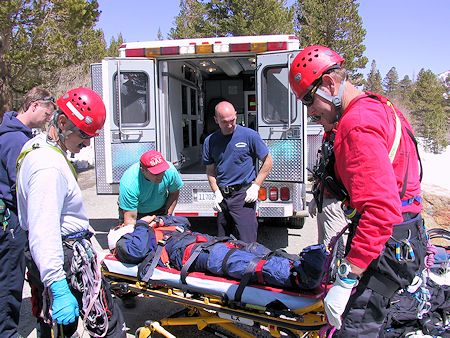 Preparing to load victim in ambulance - JW Photo