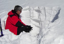 Bill Greene digging snow pit and evaluating snow