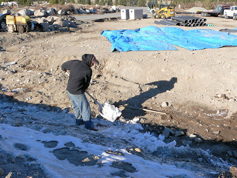 Clearing snow to resume covering drainage pipe - December 5, 2011
