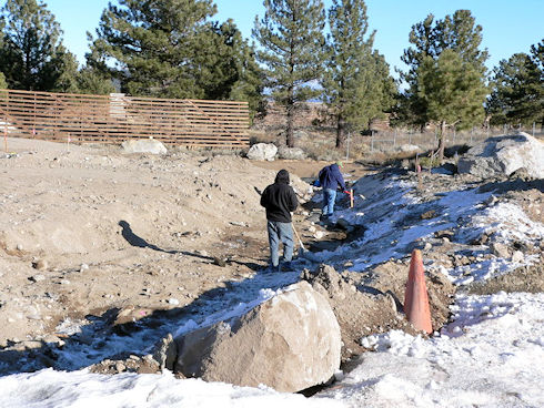 Clearing snow to resume covering drainage pipe - December 5, 2011